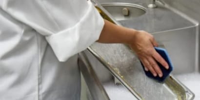 person cleaning a sink